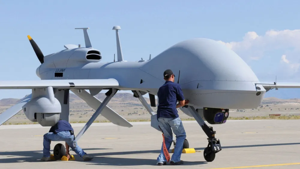 FILE PHOTO: Workers prepare an MQ-1C Gray Eagle unmanned aerial vehicle for static display at Michael Army Airfield, Dugway Proving Ground in Utah in this September 15, 2011 US Army handout photo obtained by Reuters February 6, 2013.  REUTERS/U.S. Army/Spc. Latoya Wiggins/Handout  THIS IMAGE HAS BEEN SUPPLIED BY A THIRD PARTY. IT IS DISTRIBUTED, EXACTLY AS RECEIVED BY REUTERS, AS A SERVICE TO CLIENTS. FOR EDITORIAL USE ONLY. NOT FOR SALE FOR MARKETING OR ADVERTISING CAMPAIGNS/File Photo