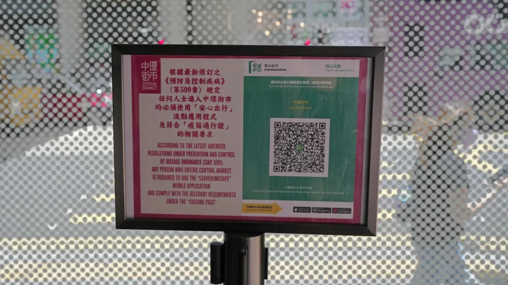 A government's contact tracing QR code for the "LeaveHomeSafe" COVID-19 mobile app is displayed at a shopping mall in Hong Kong, Tuesday, July 12, 2022. Hong Kong's leader John Lee on Tuesday defended plans to introduce a new virus "health code" that would use mobile phones to classify people as "red" or "yellow" and limit their movement. (AP Photo/Kin Cheung)