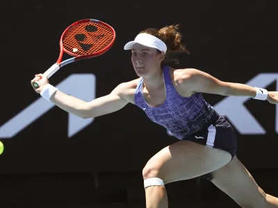 Tamara Zidansek of Slovenia plays a forehand return to Heather Watson of Britain during their second round match at the Australian Open tennis championships in Melbourne, Australia, Thursday, Jan. 20, 2022. (AP Photo/Tertius Pickard)