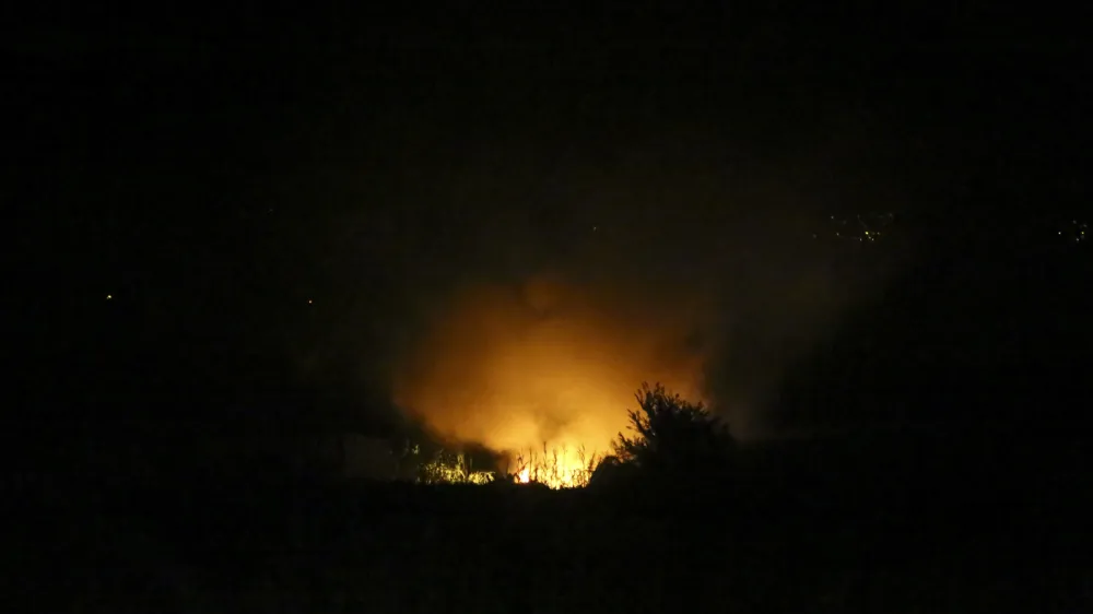 Flames are seen at the site of a plane crash, a few miles away from the city of Kavala, in northern Greece, Saturday, July 16, 2022. An Antonov cargo plane operated by a Ukraine-based air carrier crashed Saturday near the city of Kavala in northern Greece, authorities said. Greek Civil Aviation authorities say the flight was heading from Serbia to Jordan, but have not been able to confirm how many people were on board or what the plane's cargo was. (Ilias Kotsireas/InTime News via AP)