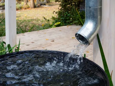 Water drains from the drain pipe into a metal container