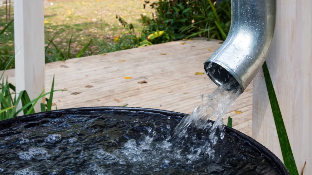 Water drains from the drain pipe into a metal container