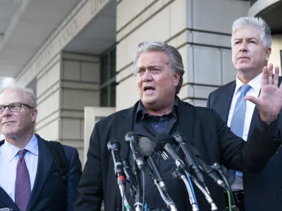 Former White House strategist Steve Bannon, center, speaks with reporters as he departs federal court on Tuesday, July 19, 2022, in Washington. Accompanying Bannon are his attorneys David Schoen, left, and M. Evan Corcoran. Bannon, a one-time adviser to former President Donald Trump, faces criminal contempt of Congress charges after refusing for months to cooperate with the House committee investigating the Jan. 6, 2021, Capitol insurrection. (AP Photo/Alex Brandon)