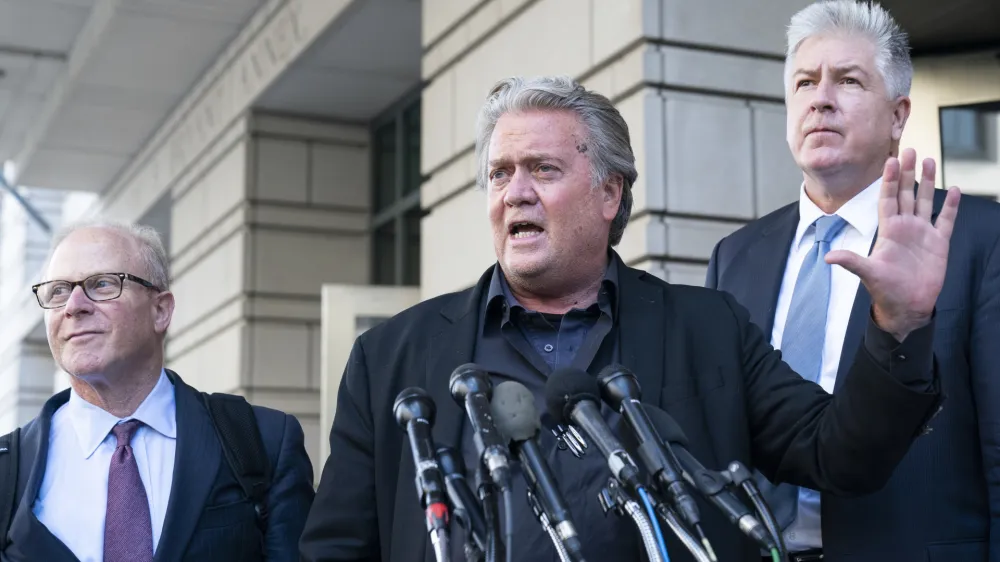 Former White House strategist Steve Bannon, center, speaks with reporters as he departs federal court on Tuesday, July 19, 2022, in Washington. Accompanying Bannon are his attorneys David Schoen, left, and M. Evan Corcoran. Bannon, a one-time adviser to former President Donald Trump, faces criminal contempt of Congress charges after refusing for months to cooperate with the House committee investigating the Jan. 6, 2021, Capitol insurrection. (AP Photo/Alex Brandon)