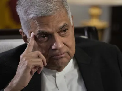 FILE - Sri Lanka's new Prime Minister Ranil Wickremesinghe gestures during an interview with The Associated Press in Colombo, Sri Lanka, Saturday, June 11, 2022. Sri Lanka's prime minister and acting president, Wickremesinghe, will face two rivals in a parliamentary vote Wednesday, July 20, on who will succeed the ousted leader who fled the country last week amid huge protests triggered by its economic collapse. (AP Photo/Eranga Jayawardena, File)