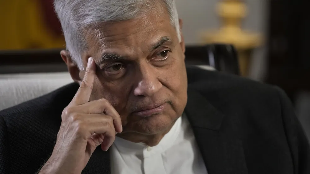 FILE - Sri Lanka's new Prime Minister Ranil Wickremesinghe gestures during an interview with The Associated Press in Colombo, Sri Lanka, Saturday, June 11, 2022. Sri Lanka's prime minister and acting president, Wickremesinghe, will face two rivals in a parliamentary vote Wednesday, July 20, on who will succeed the ousted leader who fled the country last week amid huge protests triggered by its economic collapse. (AP Photo/Eranga Jayawardena, File)