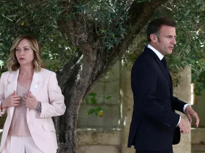 French President Emmanuel Macron walks next to Italy's Prime Minister Giorgia Meloni on the first day of the G7 summit, at the Borgo Egnazia resort, in Savelletri, Italy June 13, 2024. REUTERS/Guglielmo Mangiapane