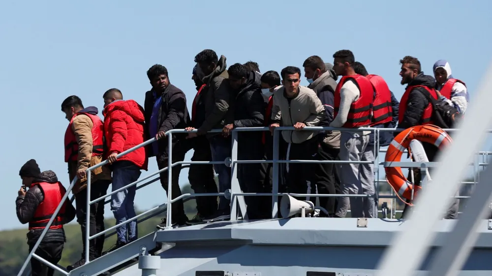 FILE PHOTO: Migrants disembark at the Port of Dover, after being rescued while crossing the English Channel, in Dover, Britain, June 14, 2022. REUTERS/Matthew Childs/File Photo