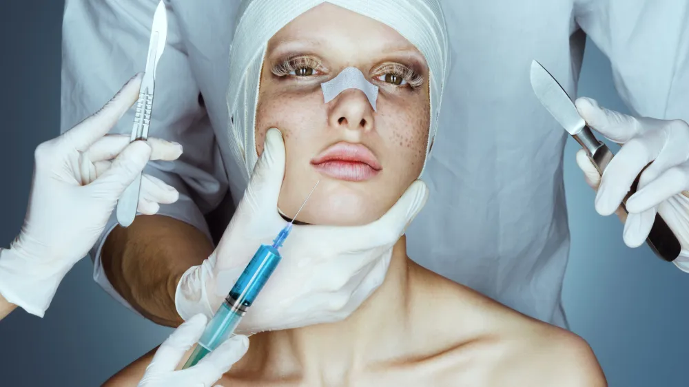 Patient in bandages. Nurses holding scalpel and syringe near her face. Plastic Surgery concept