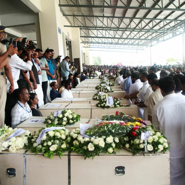 People gather around the coffins containing the bodies of people who died during a fire that broke out in a building housing foreign workers in Kuwait, upon their arrival at Cochin International Airport, in Kochi, in the southern Indian state of Kerala, June 14, 2024. Reuters/Sivaram V