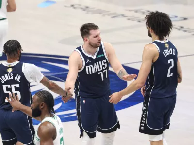 Jun 14, 2024; Dallas, Texas, USA; Dallas Mavericks guard Luka Doncic (77) high fives center Dereck Lively II (2) and forward Derrick Jones Jr. (55) during the first quarter against the Boston Celtics during game four of the 2024 NBA Finals at American Airlines Center. Mandatory Credit: Kevin Jairaj-USA TODAY Sports