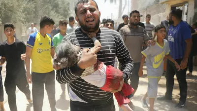 SENSITIVE MATERIAL. THIS IMAGE MAY OFFEND OR DISTURB A Palestinian man carries an injured child following an Israeli strike, amid the Israel-Hamas conflict, in Deir Al-Balah, in the central Gaza Strip, June 14, 2024. REUTERS/Abed Khaled