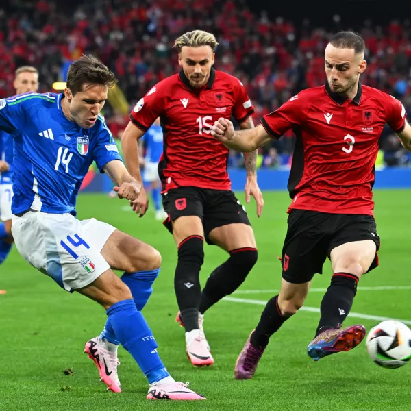 15 June 2024, North Rhine-Westphalia, Dortmund: Italy's Federico Chiesa (L) battle for the ball with Albania's Taulant Seferi (C) and Mario Mitaj during the UEFA Euro 2024 group B soccer match between Italy and Albania at the Dortmund stadium. Photo: Bernd Thissen/dpa