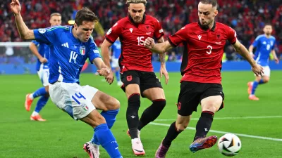 15 June 2024, North Rhine-Westphalia, Dortmund: Italy's Federico Chiesa (L) battle for the ball with Albania's Taulant Seferi (C) and Mario Mitaj during the UEFA Euro 2024 group B soccer match between Italy and Albania at the Dortmund stadium. Photo: Bernd Thissen/dpa