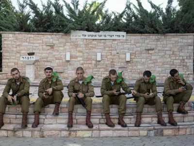 Soldiers take a rest after the funeral of Israeli soldier Staff sergeant Stanislav Kostarev, who was killed amid the ongoing conflict in Gaza between Israel and Hamas, in Ashdod, Israel, June 16, 2024. REUTERS/Marko Djurica