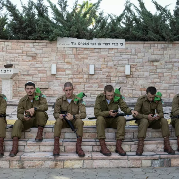 Soldiers take a rest after the funeral of Israeli soldier Staff sergeant Stanislav Kostarev, who was killed amid the ongoing conflict in Gaza between Israel and Hamas, in Ashdod, Israel, June 16, 2024. REUTERS/Marko Djurica