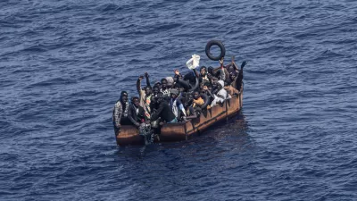 PRODUCTION - 29 June 2023, Italy, Lampedusa: Migrants trying to reach the Italian island of Lampedusa from the northern coast of Africa are apparently adrift in the Mediterranean Sea with engine trouble. More and more African refugees are crossing to Italy from Tunisia. Many migrants pay a high price for the journey, not only financially. Photo: Oliver Weiken/dpa