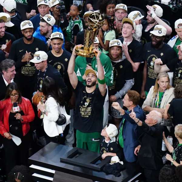 Jun 17, 2024; Boston, Massachusetts, USA; Boston Celtics forward Jayson Tatum (0) celebrates with the trophy on the podium after defeating the Dallas Mavericks in the 2024 NBA Finals at TD Garden. Mandatory Credit: David Butler II-USA TODAY Sports