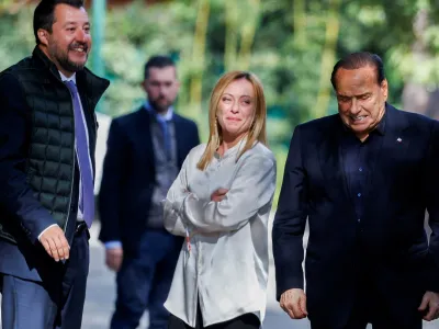 FILE PHOTO: Former Italian Prime Minister and leader of the Forza Italia party Silvio Berlusconi reacts at the end of a meeting with League leader Matteo Salvini and Brothers of Italy leader Giorgia Meloni in Rome, Italy, October 20, 2021. REUTERS/Guglielmo Mangiapane/File Photo