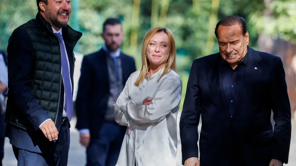 FILE PHOTO: Former Italian Prime Minister and leader of the Forza Italia party Silvio Berlusconi reacts at the end of a meeting with League leader Matteo Salvini and Brothers of Italy leader Giorgia Meloni in Rome, Italy, October 20, 2021. REUTERS/Guglielmo Mangiapane/File Photo