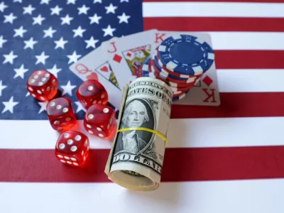 Cards, gambling dices, U.S. dollar banknotes and U.S. flag are seen in this illustration taken, June 17, 2024. REUTERS/Dado Ruvic/Illustration