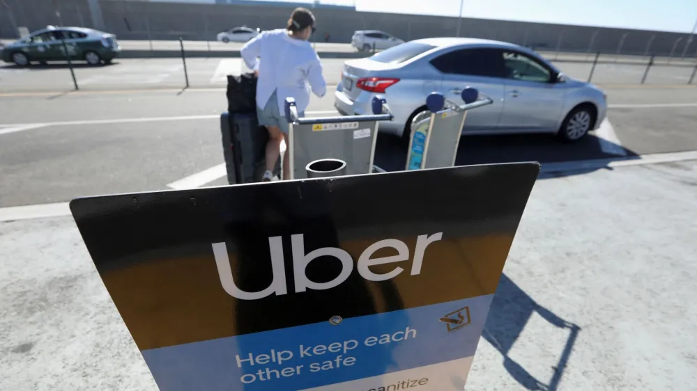 Uber signage is posted at Los Angeles International Airport (LAX) in Los Angeles, California, U.S. July 10, 2022. REUTERS/David Swanson