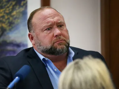 FILE PHOTO: Alex Jones attempts to answer questions about his emails asked by Mark Bankston, lawyer for Neil Heslin and Scarlett Lewis, during trial at the Travis County Courthouse, Austin, Texas, U.S., August 3, 2022. Briana Sanchez/Pool via REUTERS/File Photo