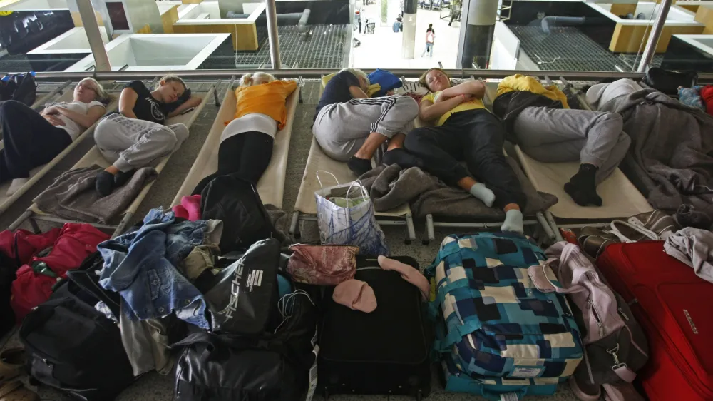 Passengers waiting for a flight to Helsinki sleep on cots at Lisbon's international Portela Airport Monday morning, May 10, 2010. The airport reopened in the late morning after being cosed for ten hours due to an ash cloud drifting over from a volcano in Iceland that caused major air travel chaos last month. (AP Photo/ Francisco Seco)