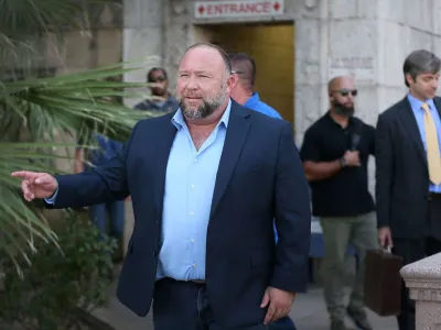 Alex Jones steps outside of the Travis County Courthouse, to do interviews with media after he was questioned under oath about text messages and emails by lawyer Mark Bankston, in Austin, Texas, U.S. August 3, 2022. Briana Sanchez/Pool via REUTERS