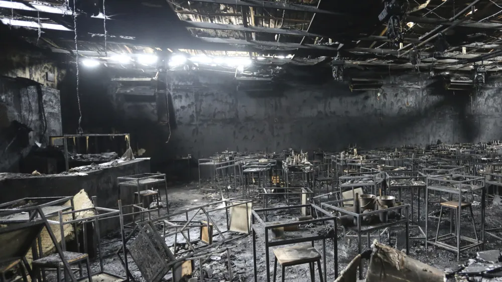 Major fire damage fills the interior at the Mountain B pub in the Sattahip district of Chonburi province, about 160 kilometers (100 miles) southeast of Bangkok, Thailand. Over a dozen people were killed and dozens injured when a fire broke out early Friday morning at the crowded music pub, police and rescue workers said. (AP Photo/Anuthep Cheysakron)