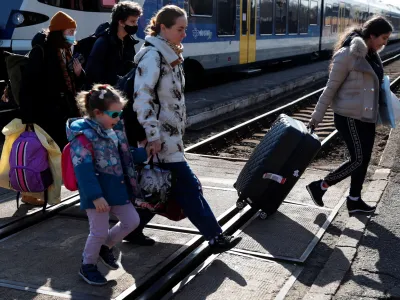 People fleeing from Ukraine to Hungary arrive at the train station, after Russia launched a massive military operation against Ukraine, in Zahony, Hungary, February 27, 2022. REUTERS/Bernadett Szabo