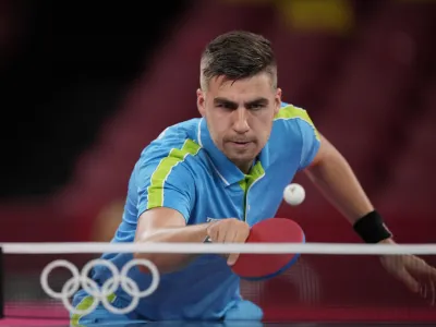 Slovenia's Jorgic Darko competes during the table tennis men's singles quarterfinal match against Taiwan's Lin Yun-Ju at the 2020 Summer Olympics, Wednesday, July 28, 2021, in Tokyo. (AP Photo/Kin Cheung)