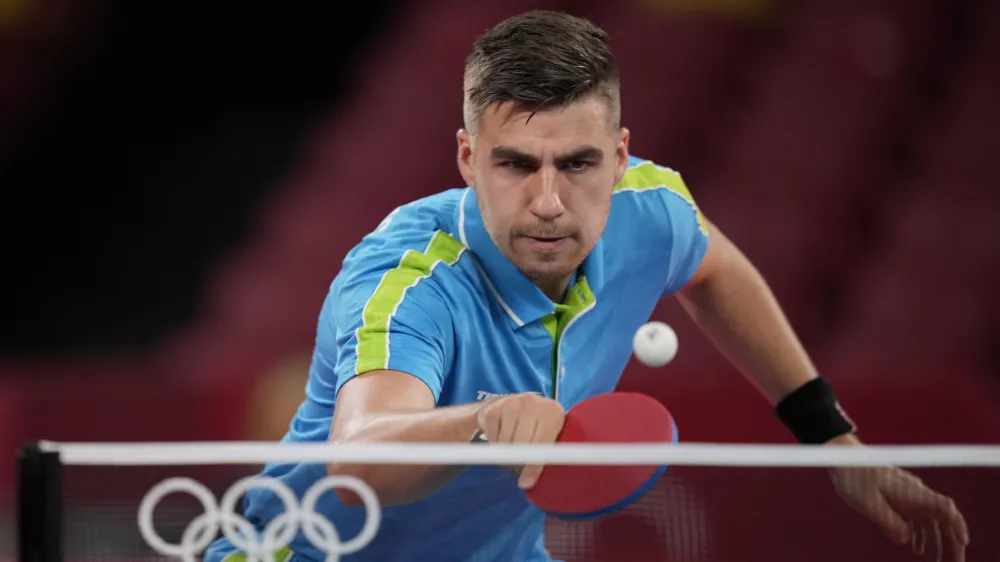 Slovenia's Jorgic Darko competes during the table tennis men's singles quarterfinal match against Taiwan's Lin Yun-Ju at the 2020 Summer Olympics, Wednesday, July 28, 2021, in Tokyo. (AP Photo/Kin Cheung)