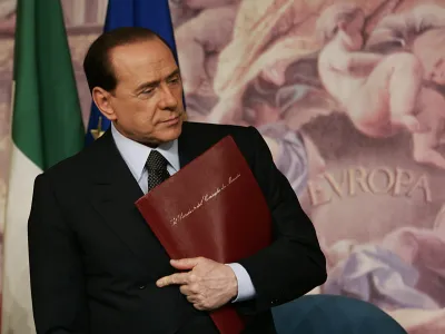 Italian Premier Silvio Berlusconi looks on at the end of a press conference at Chigi palace, the Premier's office, in Rome, Tuesday, April 11, 2006. Berlusconi suggested Tuesday that Italy could follow Germany's lead and create a "grand coalition'' if final results show neither side has control of both houses of parliament. (AP Photo/Plinio Lepri)