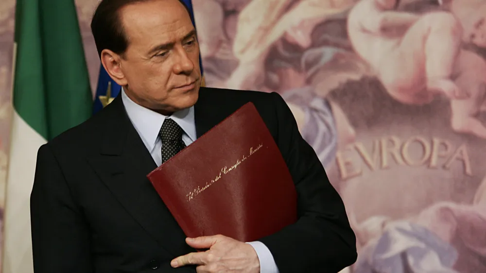 Italian Premier Silvio Berlusconi looks on at the end of a press conference at Chigi palace, the Premier's office, in Rome, Tuesday, April 11, 2006. Berlusconi suggested Tuesday that Italy could follow Germany's lead and create a "grand coalition'' if final results show neither side has control of both houses of parliament. (AP Photo/Plinio Lepri)