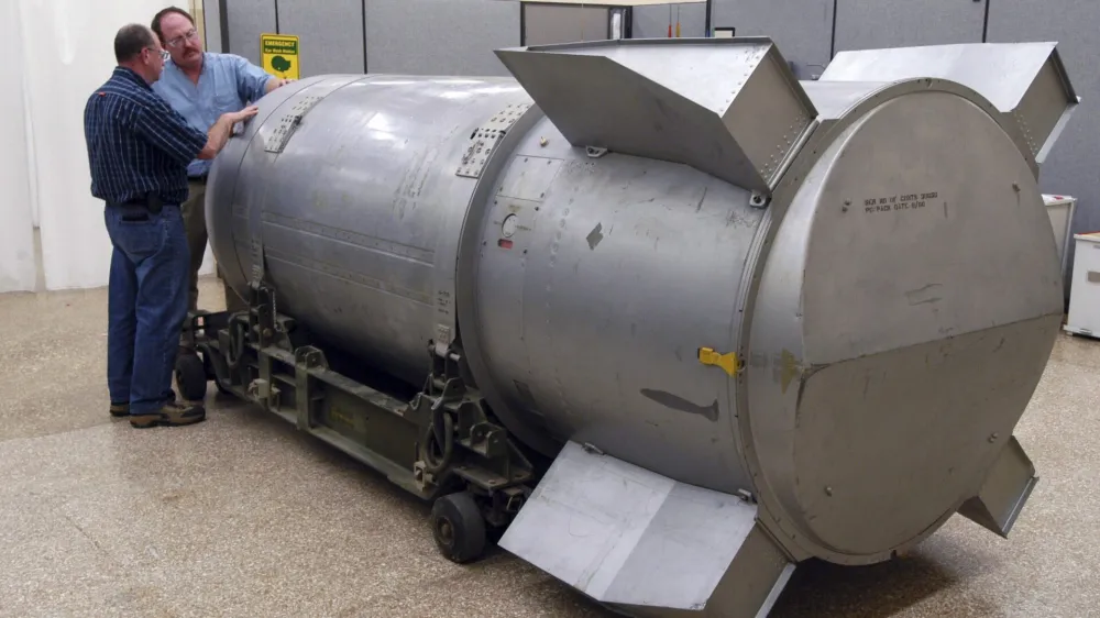 Workers examine a B53 nuclear bomb at the B&W Pantex nuclear weapons storage facility outside Amarillo, Texas, in this handout photograph taken and released on October 25, 2011. The United States dismantled the oldest nuclear bomb in its Cold War arsenal -- and one of the most powerful it ever built -- on Tuesday as part of President Barack Obama's nuclear security policy. Built at the height of the Cold War in 1962, the bomb was designed to be dropped onto a target by a massive B-52 Stratofortress strategic bomber. REUTERS/Photo Courtesy B&W Pantex/Handout (UNITED STATES - Tags: MILITARY SCIENCE TECHNOLOGY) FOR EDITORIAL USE ONLY. NOT FOR SALE FOR MARKETING OR ADVERTISING CAMPAIGNS. THIS IMAGE HAS BEEN SUPPLIED BY A THIRD PARTY. IT IS DISTRIBUTED, EXACTLY AS RECEIVED BY REUTERS, AS A SERVICE TO CLIENTS