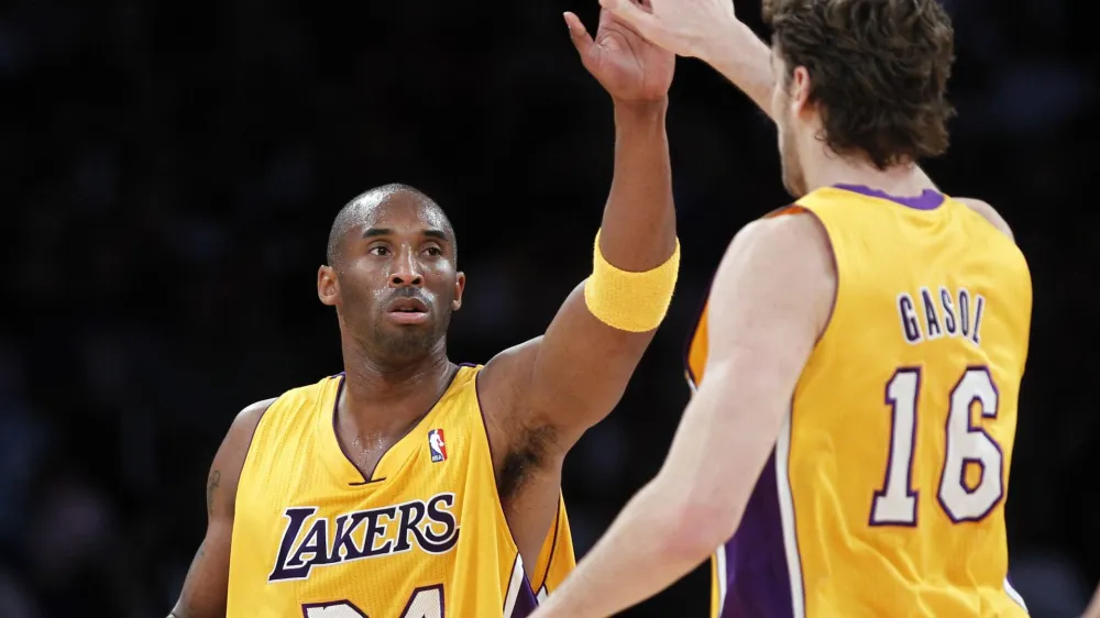 Los Angeles Lakers' Kobe Bryant (L) is congratulated by teammate Pau Gasol of Spain during their NBA basketball game against the Toronto Raptors in Los Angeles, California November 5, 2010. REUTERS/Lucy Nicholson (UNITED STATES - Tags: SPORT BASKETBALL)