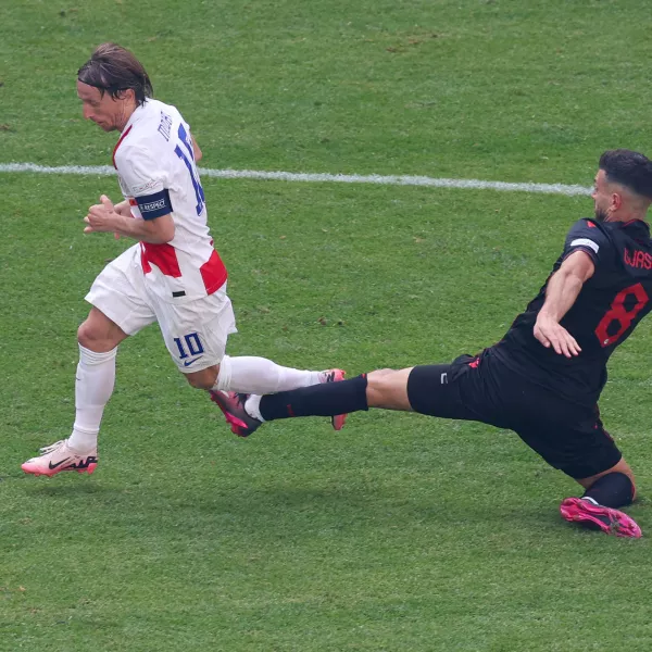 19 June 2024, Hamburg: Croatia's Luka Modric (L) and Albania's Klaus Gjasula battle for the ball during the UEFA Euro 2024 group B soccer match between Croatia and Albania at Volksparkstadion Hamburg. Photo: Jens Büttner/dpa