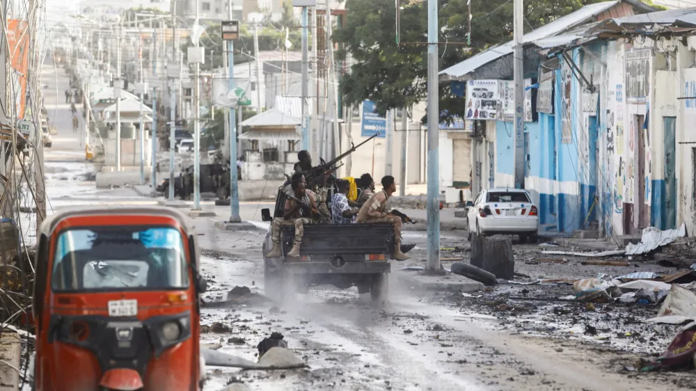 FILE PHOTO: Somali security officers drive past a section of Hotel Hayat, the scene of an al Qaeda-linked al Shabaab group militant attack in Mogadishu, Somalia August 20, 2022. REUTERS/Feisal Omar/File Photo