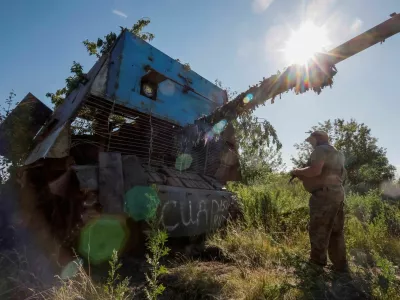 A Ukrainian serviceman of the 22nd Separate Mechanised Brigade stands next to a Russian T-62 Soviet main battle tank crafted with anti-drone protection that was recently captured by his unit, amid Russia's attack on Ukraine, at an undisclosed location in Donetsk region, Ukraine, June 19, 2024. REUTERS/Alina Smutko   TPX IMAGES OF THE DAY   REFILE - CORRECTING MONTH FROM "JULY" TO "JUNE".