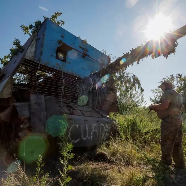 A Ukrainian serviceman of the 22nd Separate Mechanised Brigade stands next to a Russian T-62 Soviet main battle tank crafted with anti-drone protection that was recently captured by his unit, amid Russia's attack on Ukraine, at an undisclosed location in Donetsk region, Ukraine, June 19, 2024. REUTERS/Alina Smutko   TPX IMAGES OF THE DAY   REFILE - CORRECTING MONTH FROM "JULY" TO "JUNE".