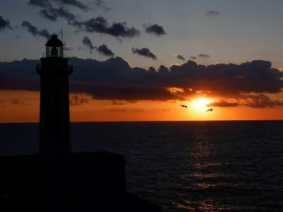 FILE PHOTO: A silhouette of a lighthouse is seen at sunset on Capri island, Italy, April 19, 2024. REUTERS/Remo Casilli/File Photo