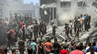 Palestinians search for casualties at the site of Israeli strikes on houses, amid Israel-Hamas conflict, at Al Shati refugee camp in Gaza City, June 22, 2024. REUTERS/Ayman Al Hassi   TPX IMAGES OF THE DAY