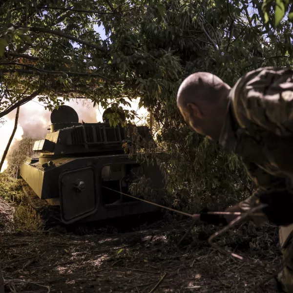 In this photo provided by Ukraine's 24th Mechanised Brigade press service, a soldier fires a "Gvozdika" 120mm Soviet-made howitzer towards Russian positions at outskirts of Chasiv Yar, Donetsk region, Ukraine, Saturday, June 22, 2024, (Oleg Petrasiuk/Ukraine's 24th Mechanised Brigade via AP)