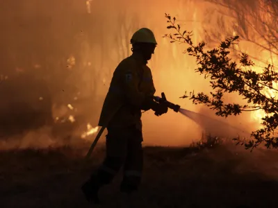 A firefighters works to stop a wildfire in Gouveia, in the Serra da Estrela mountain range, in Portugal on Thursday, Aug. 18, 2022. Authorities in Portugal said Thursday they had brought under control a wildfire that for almost two weeks raced through pine forests in the Serra da Estrela national park, but later in the day a new fire started and threatened Gouveia. (AP Photo/Joao Henriques)