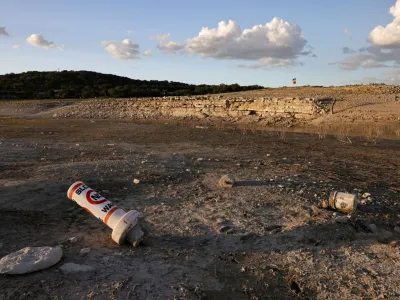 FILE PHOTO: A bouy normally used to mark "No wake" zones sits on dry land at Medina Lake outside of San Antonio as majority of Texas experiences drought amid an extreme heat wave hitting the state, in Medina County, Texas, U.S., June 18, 2022. REUTERS/Jordan Vonderhaar/File Photo