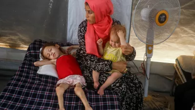 Jana Ayad, a malnourished Palestinian girl, lies on a bed as her mother sits next to her at the International Medical Corps field hospital, amid the Israel-Hamas conflict, in Deir Al-Balah in the southern Gaza Strip, June 22, 2024. REUTERS/Mohammed Salem