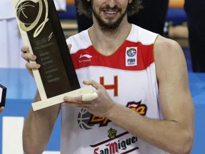 Spain's Pau Gasol holds the Most Valuable Player (MVP) trophy after winning their FIBA EuroBasket 2009 final match against Serbia in Katowice September 20, 2009.  REUTERS/Ints Kalnins (POLAND SPORT BASKETBALL)