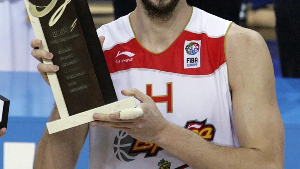 Spain's Pau Gasol holds the Most Valuable Player (MVP) trophy after winning their FIBA EuroBasket 2009 final match against Serbia in Katowice September 20, 2009.  REUTERS/Ints Kalnins (POLAND SPORT BASKETBALL)