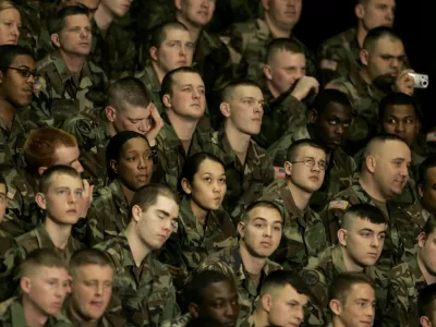 Army troops from Fort Riley, Kan., listen to President Bush deliver a speech about the war on terror during the Landon Lecture at Kansas State University Monday, Jan. 23, 2006 in Manhattan, Kan.. (AP Photo/Charlie Riedel)